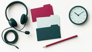 A telephone headset, three blank tabbed cards, a pencil and a small clock arranged for consultation preparation.