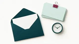 An open envelope, a clipped blank response bundle and a small clock.